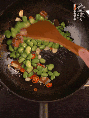 再下蠶豆煸炒，加1勺料酒調(diào)味。